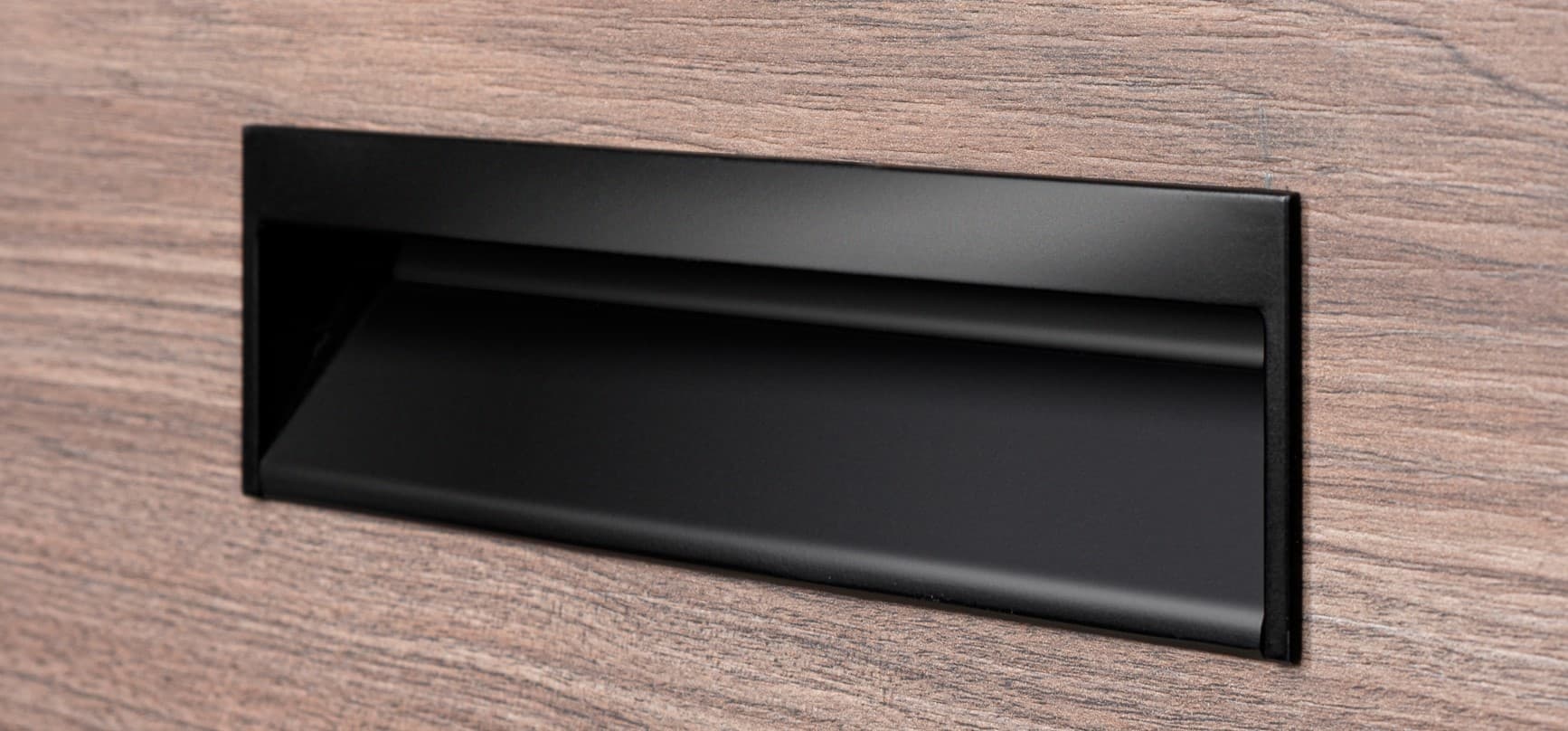 Recessed pull routed into a door